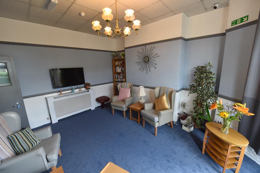 A bright and welcoming lounge at Wellfield House