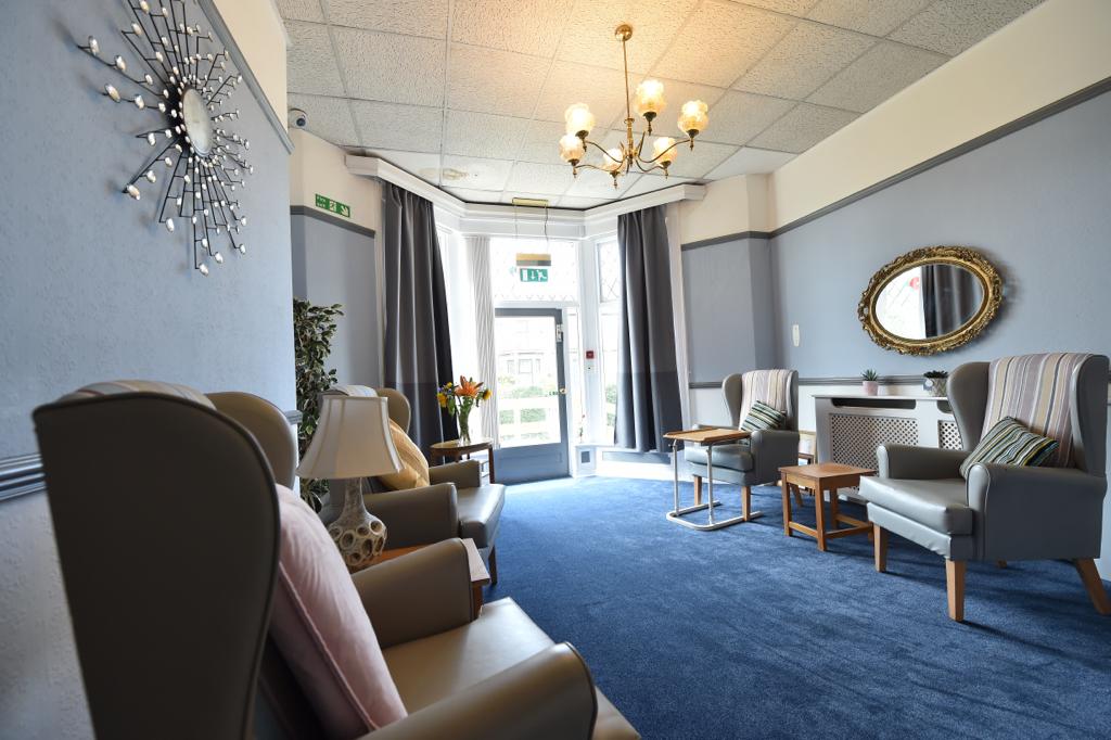 A comfortable and well-lit resident room at Wellfield House